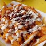 a closeup photo of Dat Dog's cheddar bacon and ranch fries